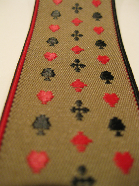 PLAYING CARDS - RED HEARTS AND DIAMONDS. BLACK CLUBS AND SPADES ON TAN BACKGROUND WITH RED AND BLACK EDGES. "Y" STYLE 1 1/3" X 48" DELUXE SUSPENDERS-Cotton/Polyester Hand Washable-Hang to Dry Material.WITH GOLD GRIPS AND 2 LENGTH ADUSTERS    YD-PLA76B48#110g